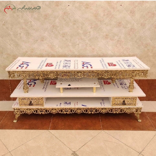 خرید، قیمت و مشخصات میز تلویزیون برنزی 2 طبقه با پایه دار با رویه هایگلس سفید و طراحی مدرن و ظریف  - چترزندگی