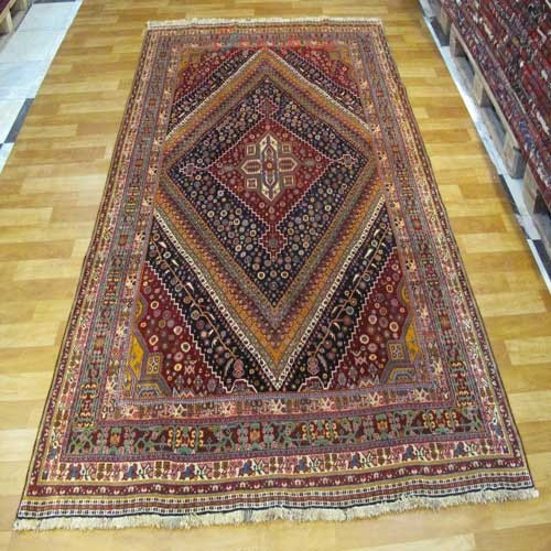 خرید آنلاین، فرش دستباف آنتیک قشقائي کشکولی کد 38517 با رنگ زمینه سرمه اي و حاشیه سبز، با زمینه شیک در طرح لچک و ترنج وزیر، زیر قیمت بازار | چترزندگی