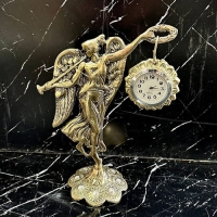 خرید، قیمت و مشخصات ساعت ایستاده برنزی به روز و شیک طرح ملکه بالدار گیتاریست طلایی رنگ زیر قیمت | چترزندگی